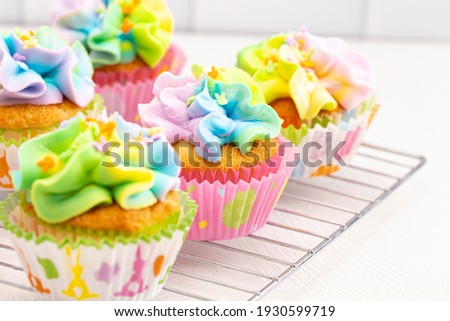 Pastel Rainbow Frosted Easter Cupcakes  on a White Kitchen Counter