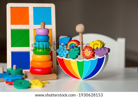 Balancer toys. Children's wooden toy in the form of an umbrella, color pyramid and educational logic toys for children. Montessori Games for child development. Royalty-Free Stock Photo #1930628153