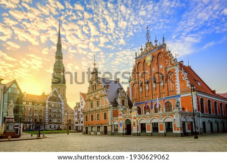 City Hall Square with House of the Blackheads and Saint Peter church in Old Town of Riga on dramatic sunrise, Latvia Royalty-Free Stock Photo #1930629062