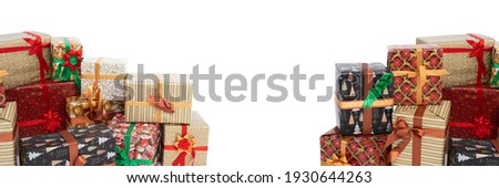 In a panoramic frame, many colorful gift boxes lie on an isolated white background. Christmas atmosphere.