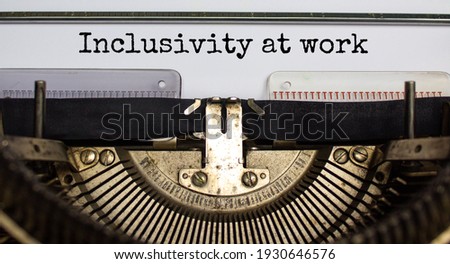Inclusivity at work and belonging symbol. Concept words 'inclusivity at work' typed on retro typewriter. Business, inclusivity at work and belonging concept. Beautiful background.