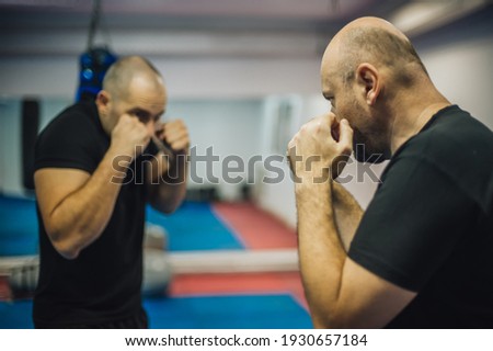 Sparring training and demonstration of street fight technique against attacker in dojo gym. Martial arts practice