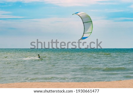 Seascape with kitesurfers in the waves. Royalty-Free Stock Photo #1930661477