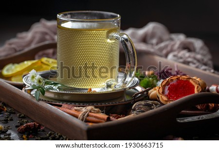 Hot tea in a cup on an old background.