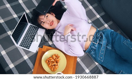 Young influencer posting pictures of her breakfast on social media. High quality photo