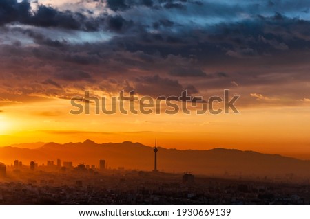 very beautiful and awesome sunrise with colorful clouds  in tehran city 