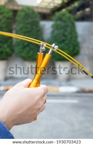 Hand of woman holding a speed jump rope, stock photo