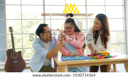 Family downs syndrome Live video clip of Wooden block toy continuation by sharing via smartphone on social media. Royalty-Free Stock Photo #1930714364