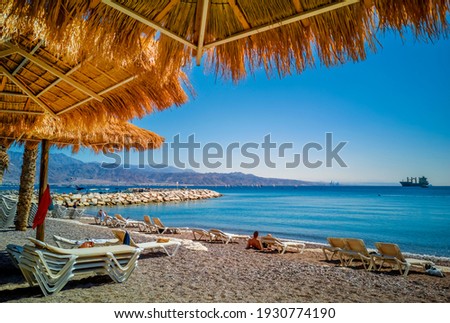 
Morning view on the Red Sea on a public beach of Eilat - famous resort city in Israel.This the most southern coral reef location is a popular tropical getaway for tourists. 
 Royalty-Free Stock Photo #1930774190