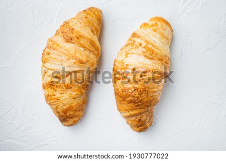 Tasty buttery croissants set, on white stone background, top view flat lay