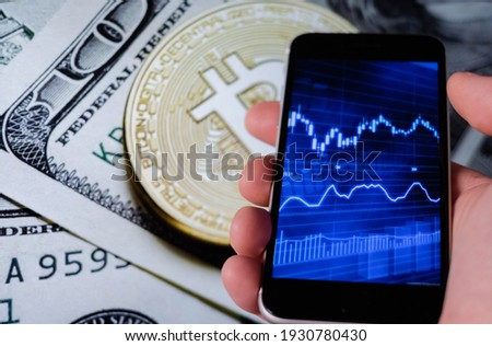 Bitcoin and cryptocurrency investing concept. Mobile phone application to trade Bitcoin BTC in modern graphic interface. Blockchain and financial technology.