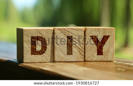 Wood cube blocks with letters DIY on red background. business concept with nature background