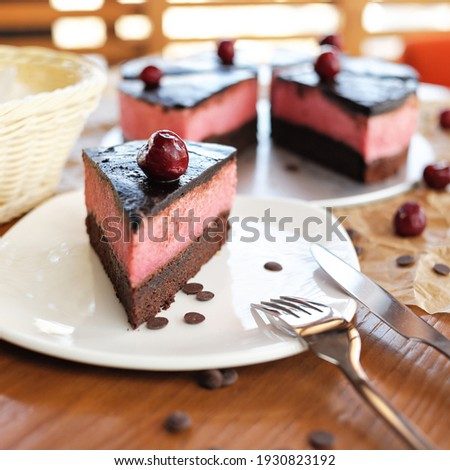 Cherry on piece of chocolate cake. Sweet gift or present for beloved person or woman. Holiday or festive mood concept. Exquisite goodiesfor refined taste.