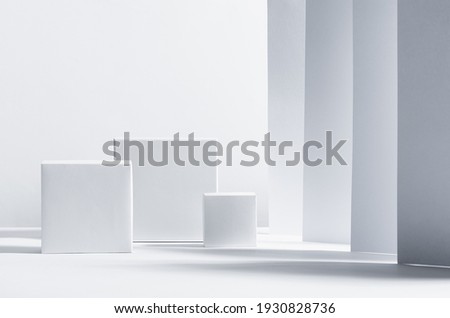 White square podiums in sunlight with shadow on white striped perspective background. Trend fashion showcase for cosmetic products, goods, shoes, bags, watches.