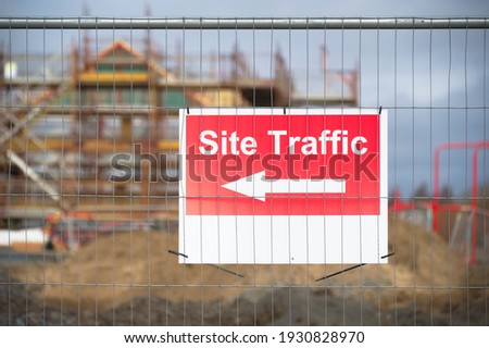 Site traffic direction sign at construction site entrance