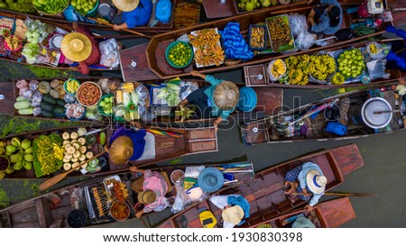 Aerial view famous floating market in Thailand, Damnoen Saduak floating market, Farmer go to sell organic products, fruits, vegetables and Thai cuisine, Tourists visiting by boat, Ratchaburi, Thailand Royalty-Free Stock Photo #1930830398