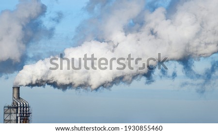 Factory chimney fumes emitting pollution to the atmosphere. co2 and greenhouse gases emissions. Royalty-Free Stock Photo #1930855460