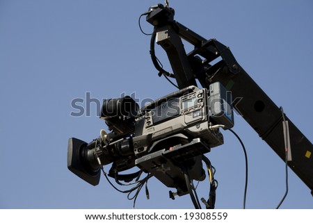 TV camera on the crane and with blue sky in the background