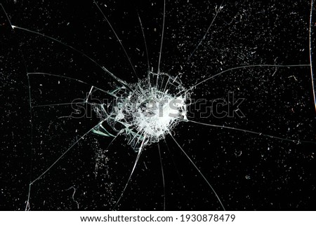 cracks on black glass background, broken abstract glass hole destruction concept Royalty-Free Stock Photo #1930878479