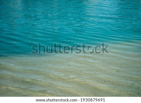 Soft waves of blue sea on sandy coast. Mediterranean sea.