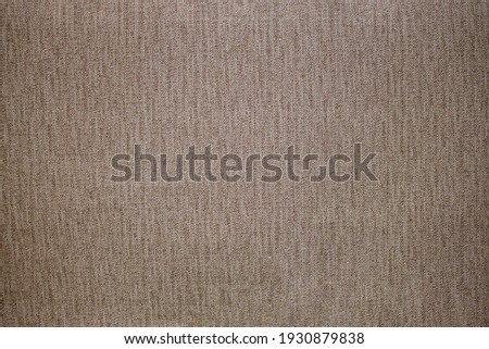 Light grey woolen or tweed fabric for grunge background.