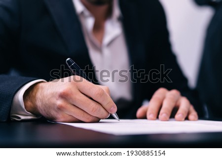 Businessman Signing An Official Document