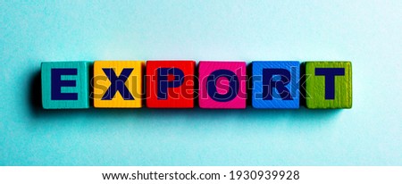 The word EXPORT is written on multicolored bright wooden cubes on a light blue background