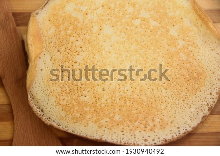 Stack of hot homemade pancakes on the wood cooking board