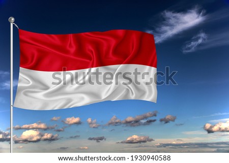Indonesia national flag waving in the wind against deep blue sky.  International relations concept.