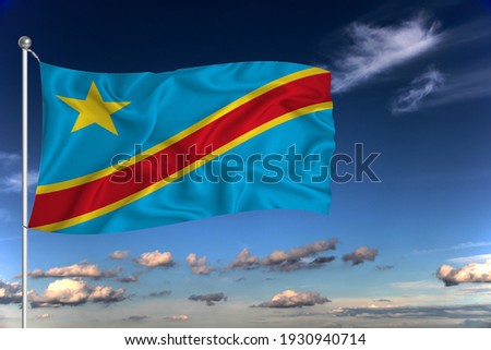 Congo national flag waving in the wind against deep blue sky.  International relations concept.