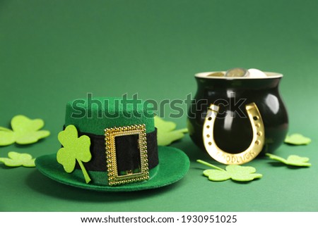 Leprechaun's hat and St. Patrick's day decor on green background