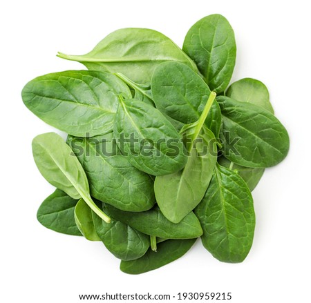 Pile of spinach leaves close-up on a white background. Top view. Royalty-Free Stock Photo #1930959215