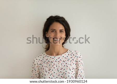 Portrait of young woman with beautiful hair perfect teeth skin condition. Cosmetology cabinet dental clinic client look at camera enjoy good self care procedure result. Studio shot on white background