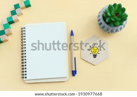 top view image of open notebook with blank pages on wooden yellow pastel background. ready for adding text or mockup.
