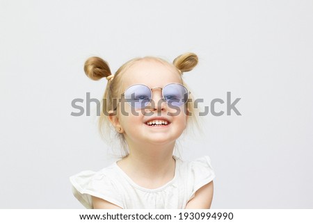 Little girl in sunglasses isolated on white background