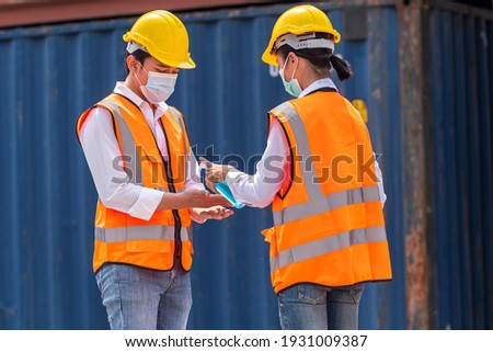 Factory workers wear face mask and safety dress cleaning hand with alcohol sanitizer gel and stand at outdoor warehouse - safety and health  protect coronavirus protocol concept