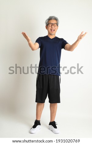 The Asian senior man with sport clothes on the white background.