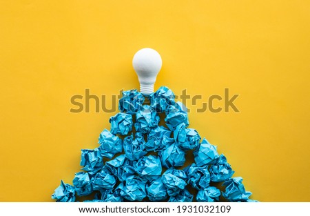 Idea and creativity concepts with lightbulb on top of paper crumpled ball in mountain shape.Think out of box.Business solution.