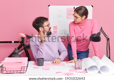 Image of woman and man have argument and misunderstanding work together at productive solution collaborate on building sketches creat architect project isolated over pink background. Teamwork