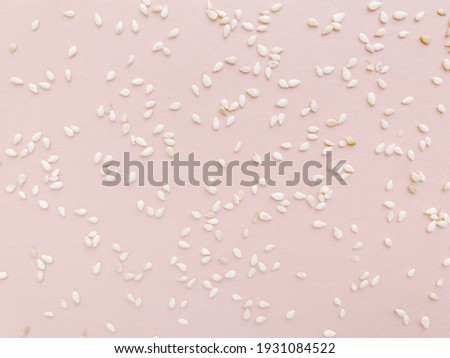 Pattern of white sesame seeds, pink delicate background