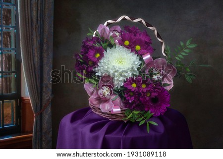 Basket with a beautiful flower arrangement on a round table