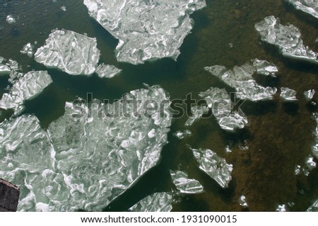 ice floe on the river in the mountains in late winter under the bright sun