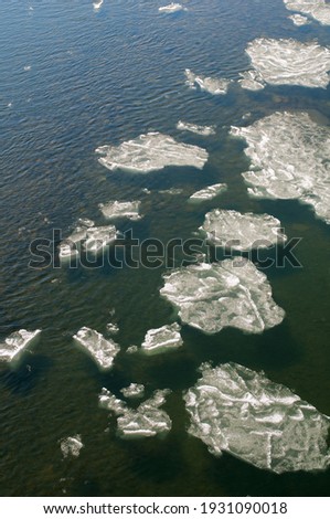 ice floe on the river in the mountains in late winter under the bright sun