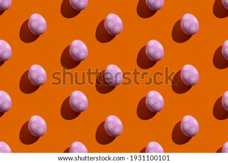 Food banner. Seamless pattern. Cute festive decor. Conceptual art. Abstract background. Pink eggs with pretty painted flower ornament isolated on orange.