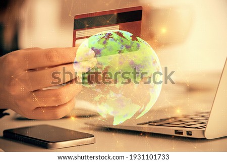 Multi exposure of woman on-line shopping holding a credit card and social network theme drawing. Relationship E-commerce concept.