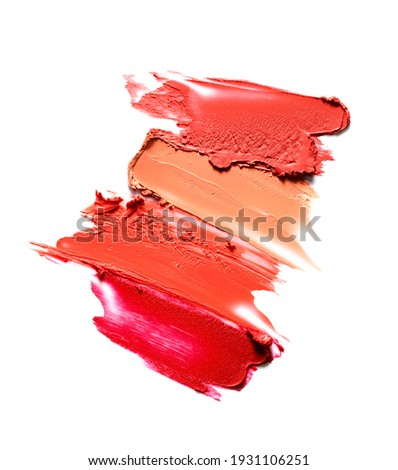 Smudged lipsticks isolated on white background