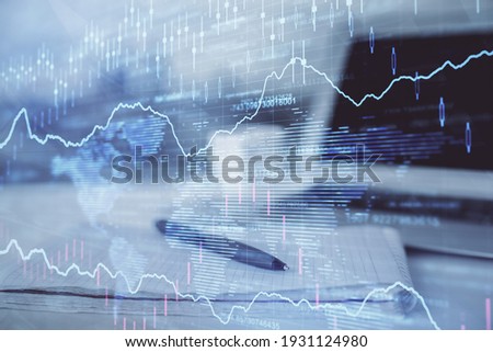 Double exposure of financial graph drawings and desk with open notebook background. Concept of forex market Royalty-Free Stock Photo #1931124980