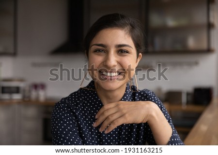 Head shot portrait close up smiling Indian woman young making video call, chatting online, looking at camera, posing for profile picture, mentor coach shooting webinar, influencer recording vlog