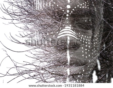 A young man's portrait with high transparency and bare branches on the background  Royalty-Free Stock Photo #1931181884