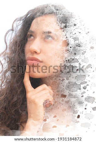 A portrait of a thoughtful young woman with curly hair combined with a black and white paint stains on a white background in paintography technique